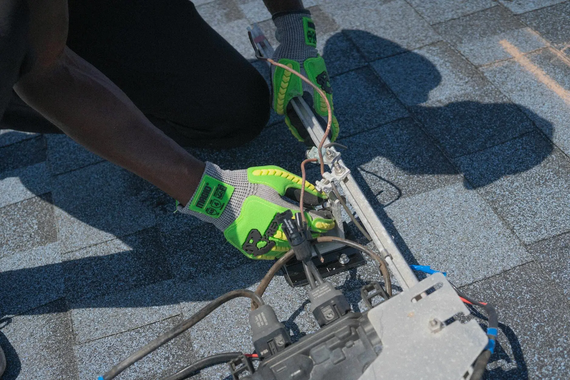 A close-up of high-quality asphalt shingles being meticulously installed on a sloped roof in Boston.