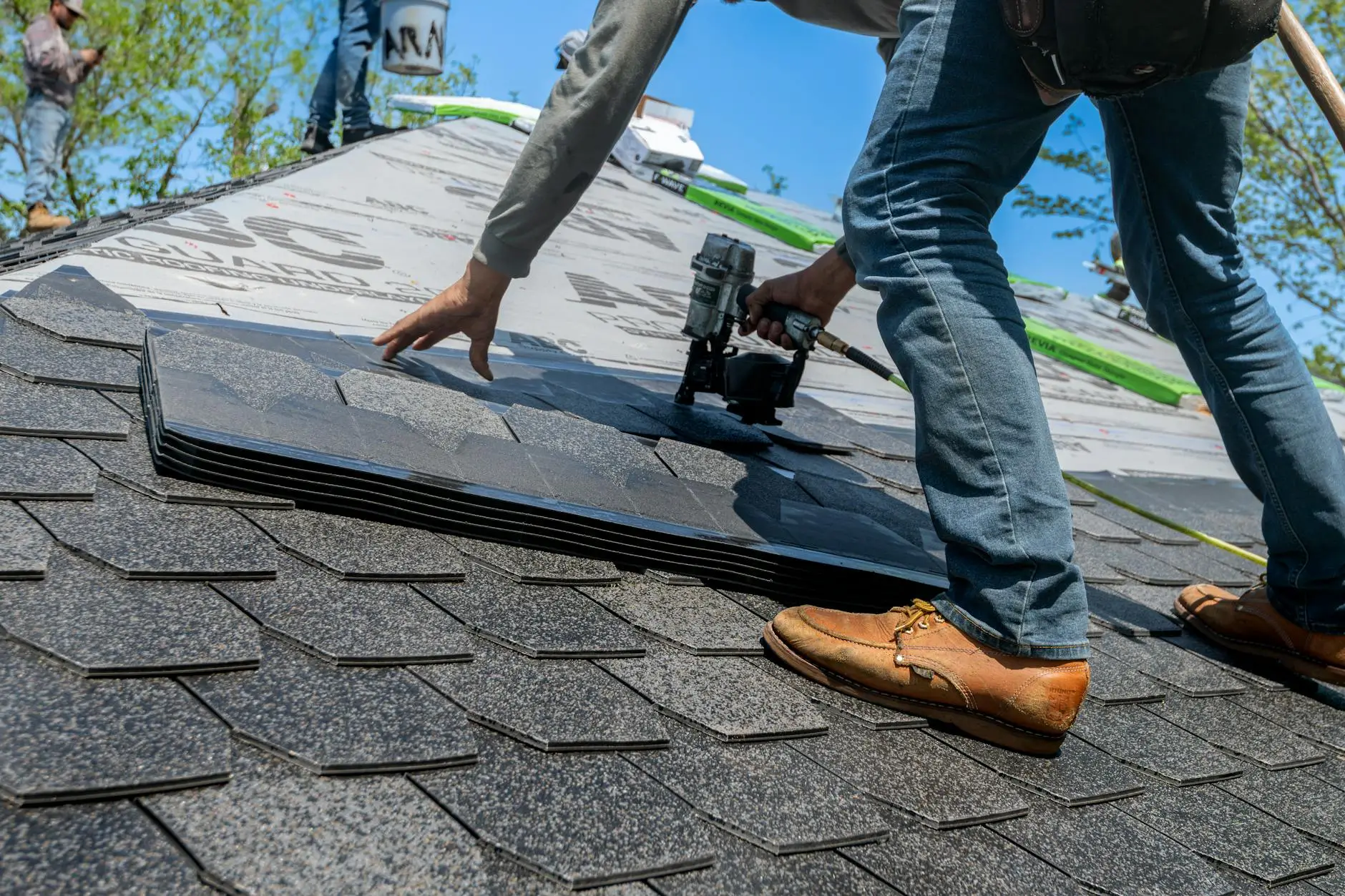 ABI Roofing crew performing an asphalt shingle tear-off and roof deck replacement on a home in Medford Oregon